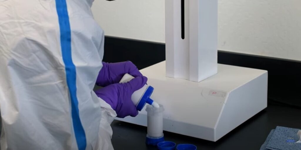 Pharmacy Technician Transferring Compounded Cream to Topi-Click, Also Used for Bi-Est