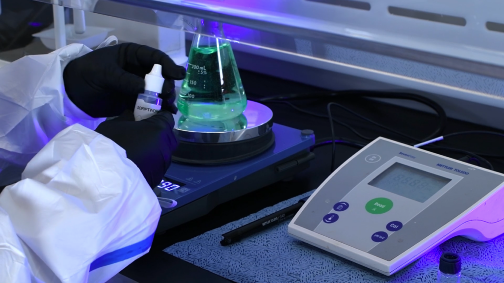 Compounding Pharmacy Technician Preparing a Liquid Solution in the Lab