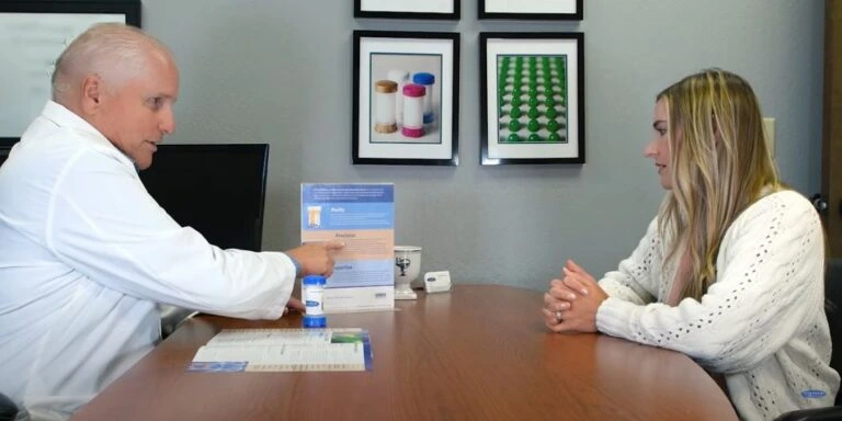 Pharmacist Reviewing Hormone Therapy Options With a Woman